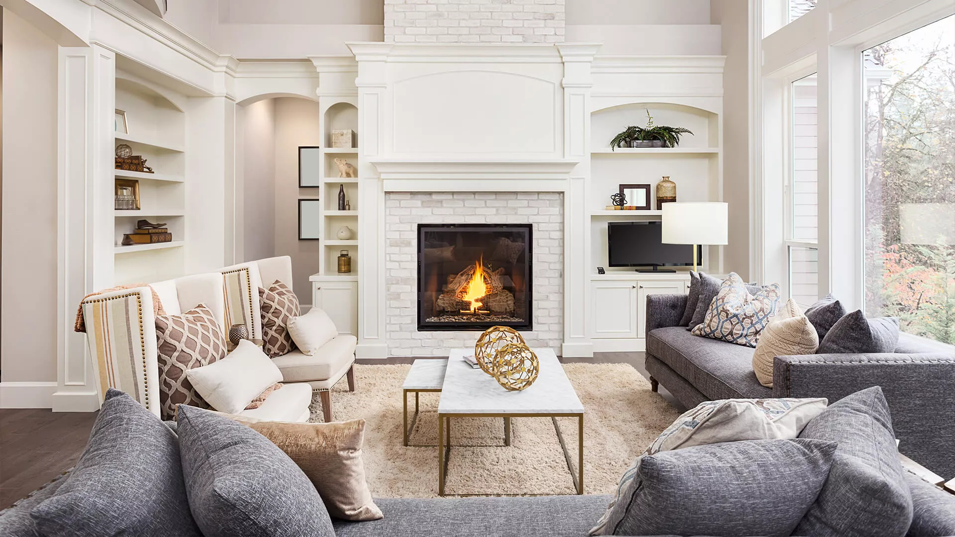 A living room with a fireplace and bookshelves.